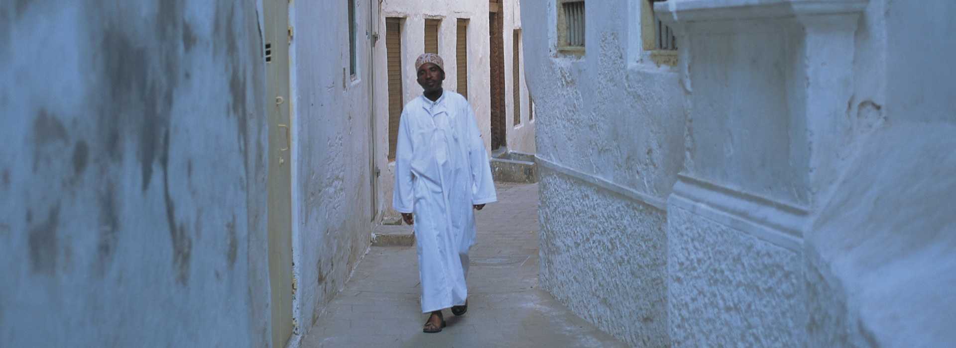 Man walking through the streets of Stone Town