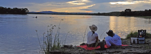 Couple overlooking the water in Selous, Tanzania, Africa