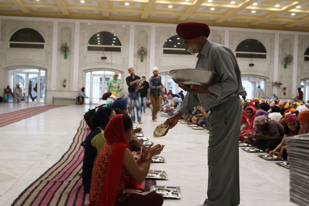 Feeding the visitors at Gurudwara Bangla Sahib