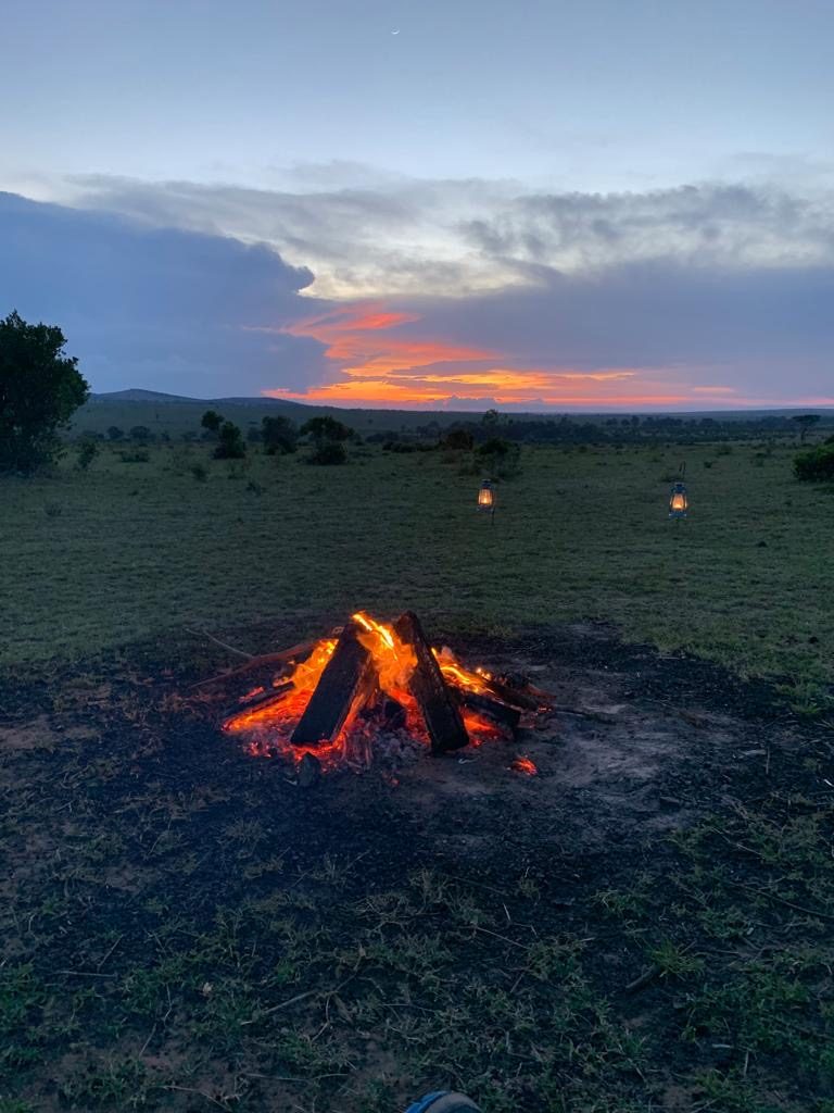 Sundowners by a Campfire watching the sunset in the Mara