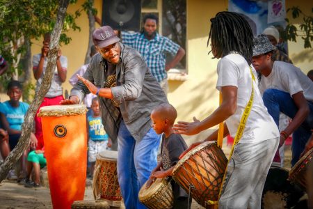 Men and small boys gathered in a drumming cirlce to drum together. Photos from Stock Image site Pixabay.