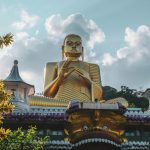 Gold Buddha temple in Sri Lanka at sunset