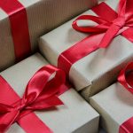 Gift boxes with brown paper and bright red ribbons