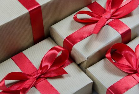 Gift boxes with brown paper and bright red ribbons