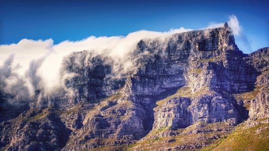 fog spreading over the top of Cape Town's Table Mountain